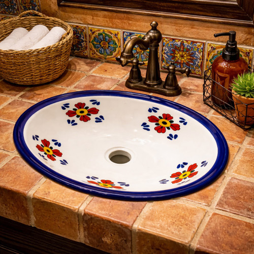 Talavera cobalt petal motif sink installed in a restaurant wash area highlighting artisan Mexican ceramic design