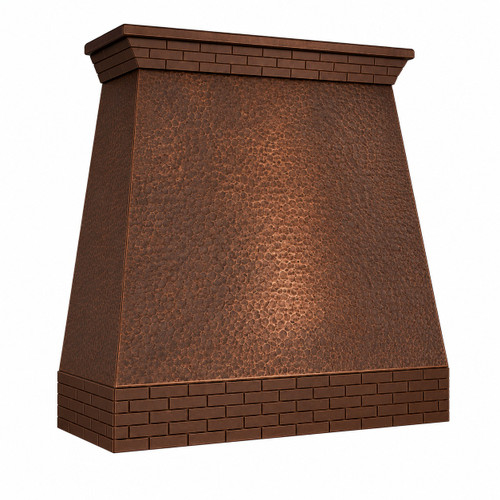 Angled front view of wall-mount hammered copper range hood with straight taper, brick apron, and crown