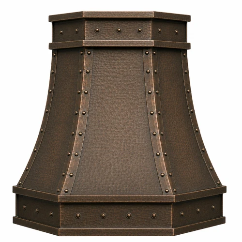 Angled faceted copper island range hood with riveted straps showing dimensional hammered panels
