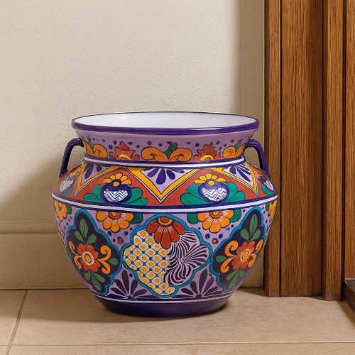 Hand-painted Talavera planter with a traditional floral design decorating a house entry