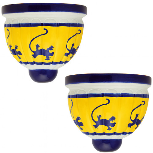 Two Mexican talavera wall sconces with yellow and cobalt lizard design on white