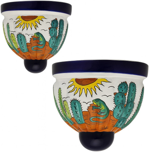 Two Mexican talavera wall sconces with lizard and desert sun design on white