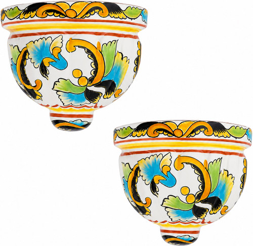 Two Mexican talavera wall sconces with yellow and turquoise scroll design on white