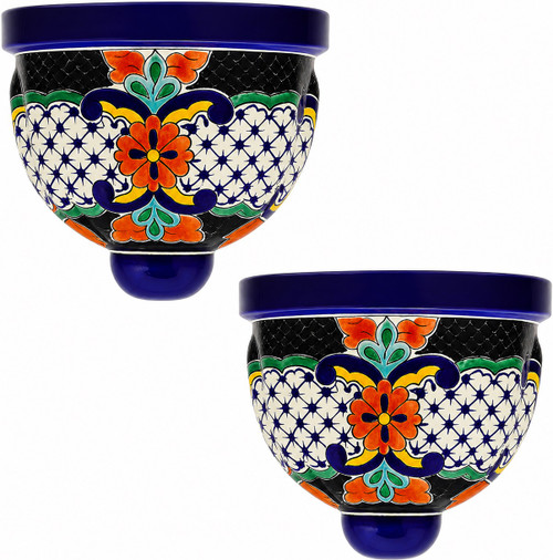 Two Mexican talavera wall sconces with red and blue lattice design on white