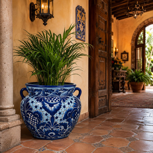 Mexican Talavera ceramic pot displayed with greenery in a traditional hacienda entryway