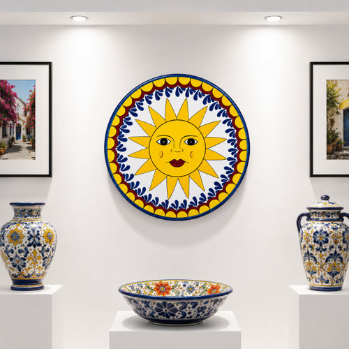 Sun face decorative talavera plate with yellow and blue design presented in a clean white gallery display