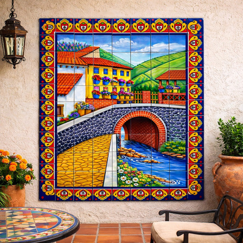 Mexican village bridge and flowers tile mural installed on house patio wall with traditional hacienda style setting
