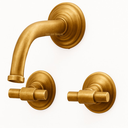 Wall mount brass faucet with T-handles and warm golden finish for a kitchen or bathroom