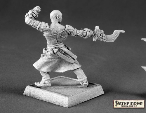 Pathfinder Sajan Iconic Male Monk. An unpainted mini seen from behind of a human man in a fighting pose, holding a sword in front of him.