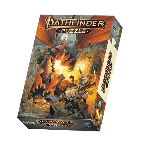 Pathfinder Puzzle — Core Rulebook product image shows a large cardboard box illustrated with a looming fire-breathing red and orange dragon bursting into an underground dungeon chamber to attack several adventurers in front of a pile of treasure; the adventurers include a male dwarf ranger with two axes, a female elf rogue with a rapier and a knife, and a female human cleric with a scimitar and a glowing holy symbol.
