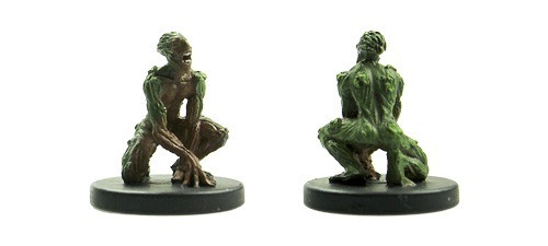 An image of a slimy green man squatted down on the ground yelling. (Front and Rear Views)