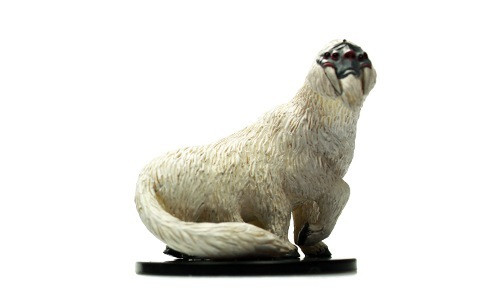 This shaggy, multi-legged creature has a flattened face with wide nostrils and four eyes. Ivory tusks jut downward, flanking its mouth. (Side View)