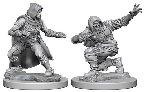 An image of the two versions of human male rogue included in this pack. The left version is in leather armor and a hooded cloak while taking a wide stance, mid-turn as if caught. The right version the same rogue crouches down on one knee and is turned half way around as if having just thrown a dagger from his left hand while his right hand actively holds a dagger up in front of his face. (Front View)