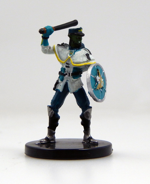 An image of a dromaar watch cadet of Absalom's city watch wearing a white jacket, dark pants, and flat cap. One arm bears a round, silver and blue shield bearing the mark of the city of Absalom while the other hand is raised to swing with a large baton. (Front View)