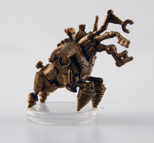 Thieves covet dig-widgets, specialized constructs built for infiltration. Each dig-widget contains numerous simple tools, including a set of mechanical devices that function as thieves' tools, two arms with drills, and two arms with corkscrews for attaching to and climbing surfaces. Once activated, these devices propel themselves forward. Though they have the full faculties typical of a construct, they usually follow a simple routine: avoid notice, pick any lock barring the path, dig past obstacles, and attack if caught. They're rarely left unattended, as a thief needs to be nearby to follow after-both to steal goods and to stop the dig-widget from engaging in further larceny once it's achieved its goal. (Side View)