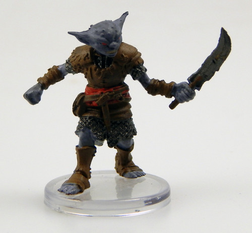 Standing as tall as a human, this muscular, gray-skinned creature peers about with tiny, observant eyes. It wears leather armor over a chain shirt. One hand holds out a crude sword ready to slash. (Front View)