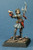 An image of a fully built and painted human cleric, Hosilla, standing confidently with a polearm at rest in the left hand and an open prayer book held forward in the right. (Front View)