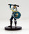 An image of a watch cadet of Absalom's city watch wearing a white jacket, dark pants, and flat cap. One arm bears a round, silver and blue shield bearing the mark of the city of Absalom while the other hand is raised to swing with a large baton. (Front View)
