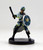 An image of a clean shaven officer of Absalom's city watch wearing a light blue jacket, dark pants, and a rounded blue helmet with a badge. One arm bears a round, silver and blue shield bearing the mark of the city of Absalom while the other hand is raised to swing with a large baton. (Front View)