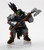 An image of a powerful, broad-shouldered orc heavily armored in gleaming full plate. In their hands they hold a necksplitting axe with a jagged cutting edge. A clutch of javelins sits on their back peeking over their shoulder. (Front View)