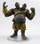 This lumbering, filthy, two-headed giant wears tattered remnants of yellow leather armor that leaves its large belly exposed. Both its hands are raised as it roars in frustration, one hand open and the other hand tightly closed into a fist. (Front View)