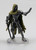 An image of an enforcer archon whose steely body looks like that of a metal construct or automaton. It wears a bone beige cloak with tattered edges. One hand is held up in a pause gesture while the other casually holds a sword. (Front View)