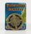 Pathfinder Compass shows a cardboard card illustrated with a partial map of a green coastline and blue ocean on which is mounted a brass-colored compass featuring a four-pointed compass rose, at the middle of which is a green and gold symbol.