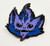 Starfinder Skittermander Pin (Blue) shows a blue and light purple furry creature’s face; the creature has pointed ears, black eyes, four nostrils, and a wide thin mouth with a few sharp teeth.