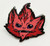 Starfinder Skittermander Pin (Red) shows a dark and light red furry creature’s face; the creature has pointed ears, black eyes, four nostrils, and a wide thin mouth with a few sharp teeth.
