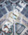 Starfinder Flip-Mat: Spaceport PDF. Sample view of a map depicting a futuristic public square with a fountain and lots of seating.