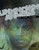 Unknown Armies Book Four: Expose PDF cover, featuring a man's face on a green and black background, with overlaid white text and geometric designs, occult-themed, by Jacobson.