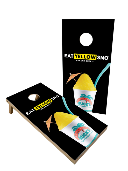 Black cornhole boards featuring a large yellow shaved ice cup graphic and the 'EAT YELLOW SNO' slogan.