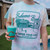 Tie-dye t-shirt in pastel colors (blue, pink, and yellow) featuring a teal graphic with the text 'Bahama Buck's' and the slogan 'FLAVOR YOUR LIFE' surrounding an illustration of a snow-shack building.