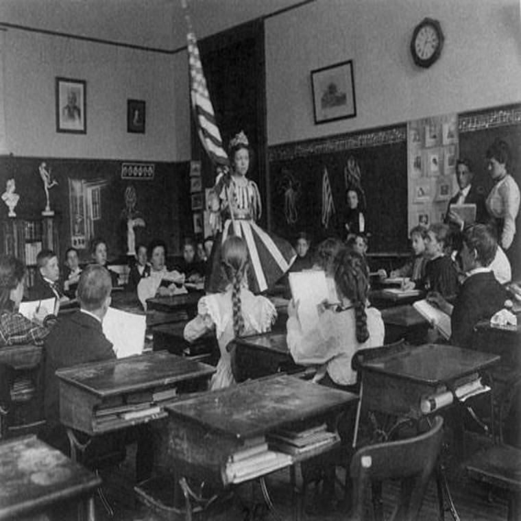 Photo of Students Sketching a Model in a Stars & Stripes Dress