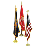 3 Flags standing on indoor flagpoles