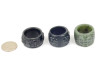 Set of three carved nephrite jade thumb rings under studio lighting