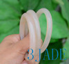 Hand holding agate bangles, showcasing smooth finish and light weight