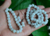 Handcrafted natural jadeite necklace, bracelet, and matching earrings with natural lighting.