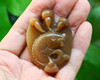 Front view of the pendant in natural light, held in hand