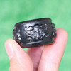 Single carved nephrite jade banzhi with beast head motif in natural light