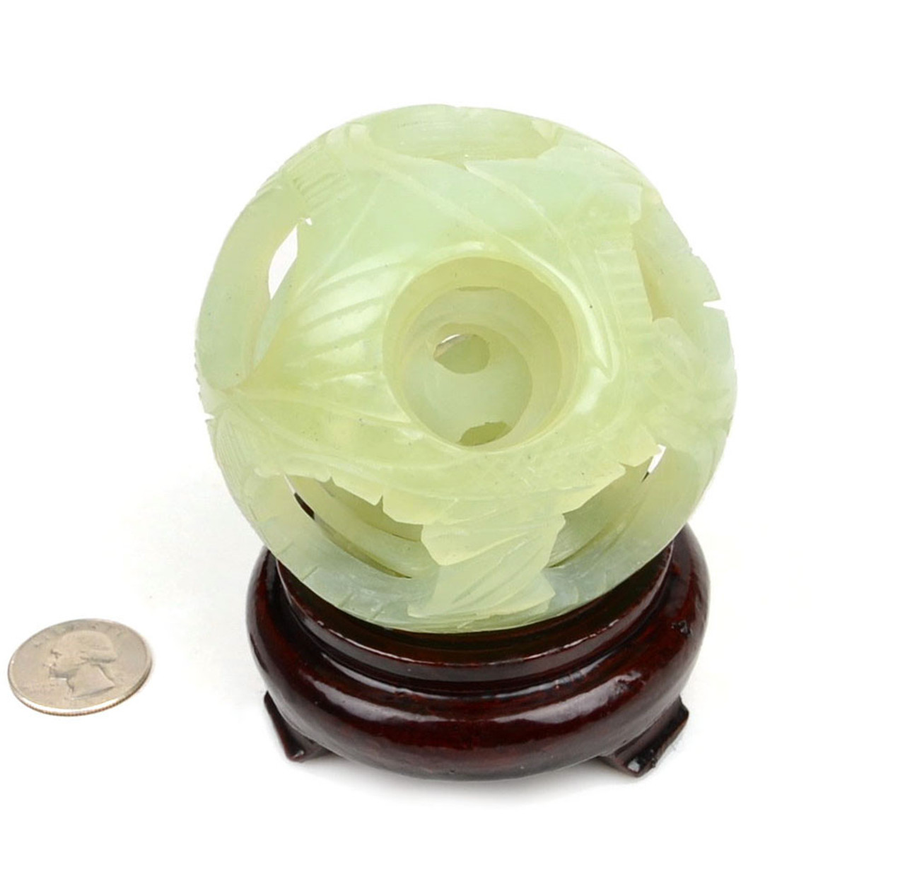 Natural serpentine jade puzzle ball with 5 layers and dragon-phoenix design on a wooden stand