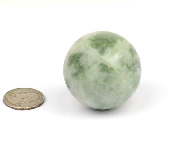 Close-up of single green-and-white jade sphere on white background