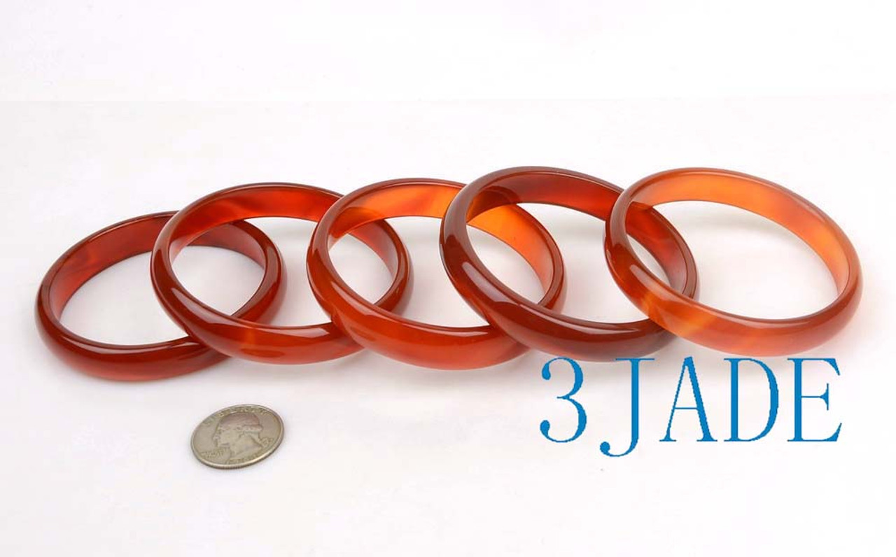 Five red agate bangles in D-shape design, grouped