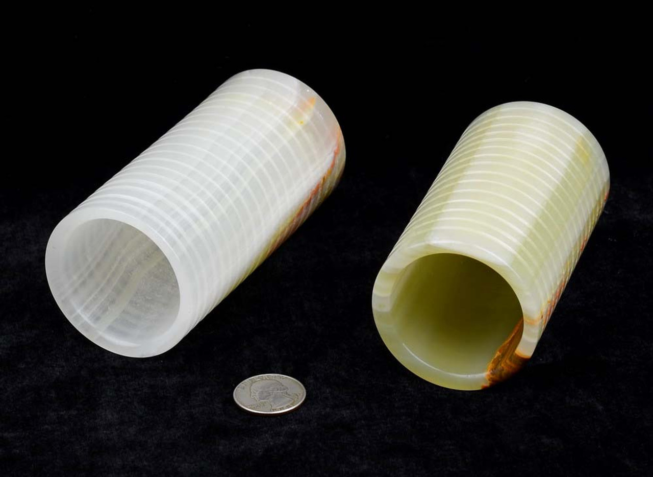 Calcite "Afghan jade" pen holders laid down, showing openings.