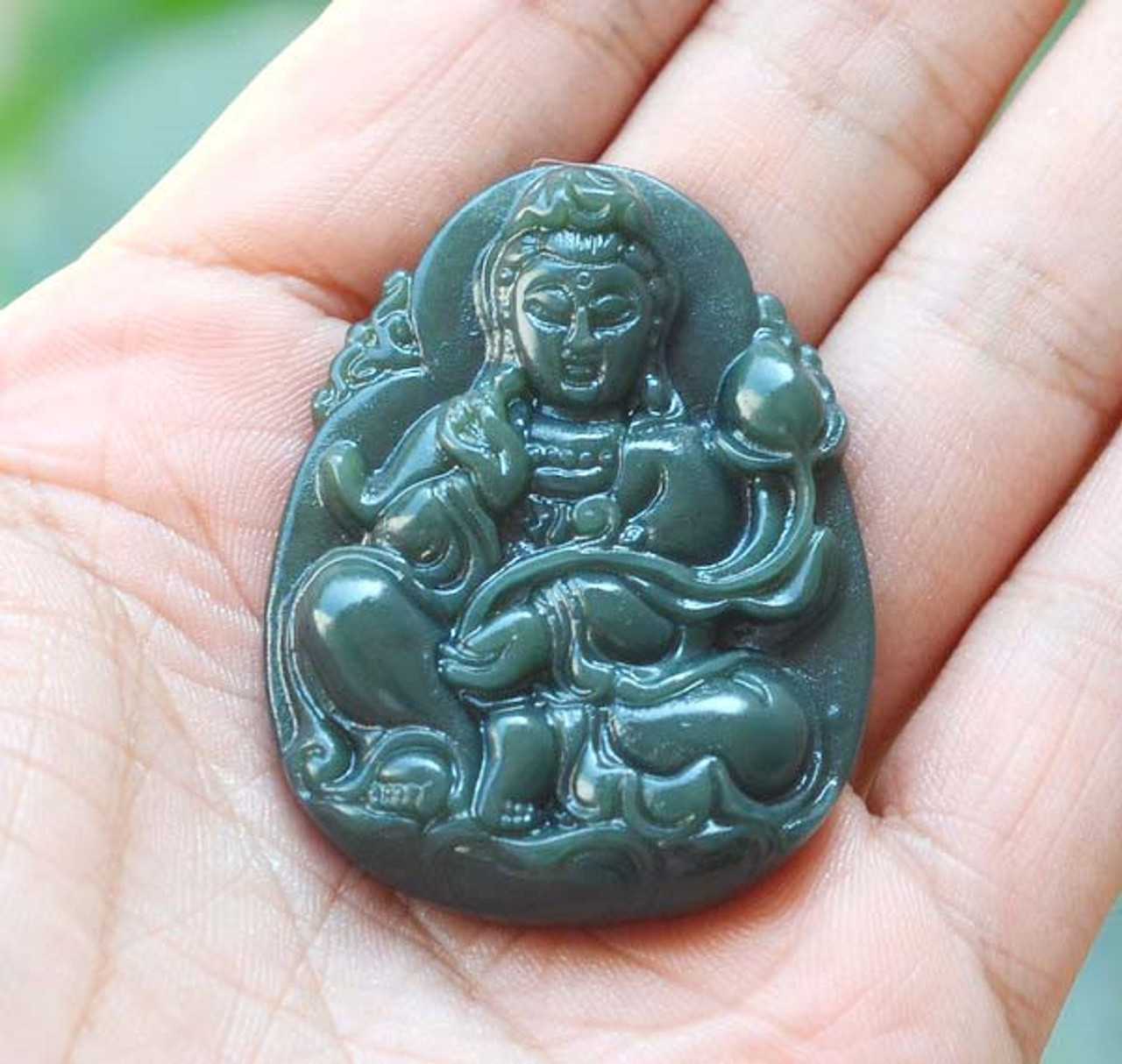 Single Guanyin pendant in hand (front view, Item 3)