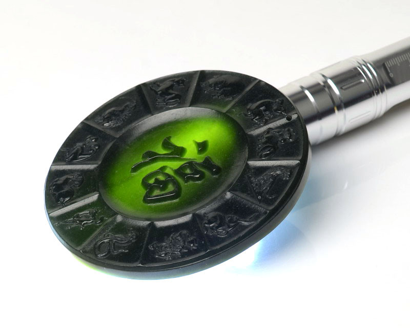 Jade disk shown under flashlight to highlight translucent nephrite jade material