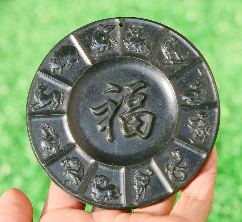 Jade plaque front view in natural light, held in hand