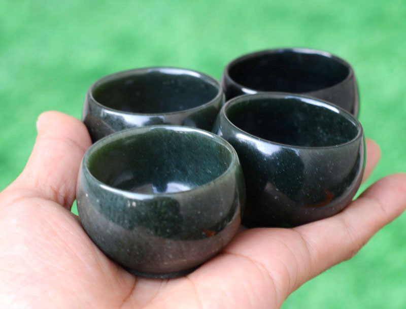 Nephrite jade yuanbao cups angled view in natural light