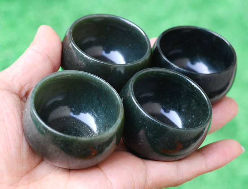 Group of nephrite jade yuanbao cups in natural light