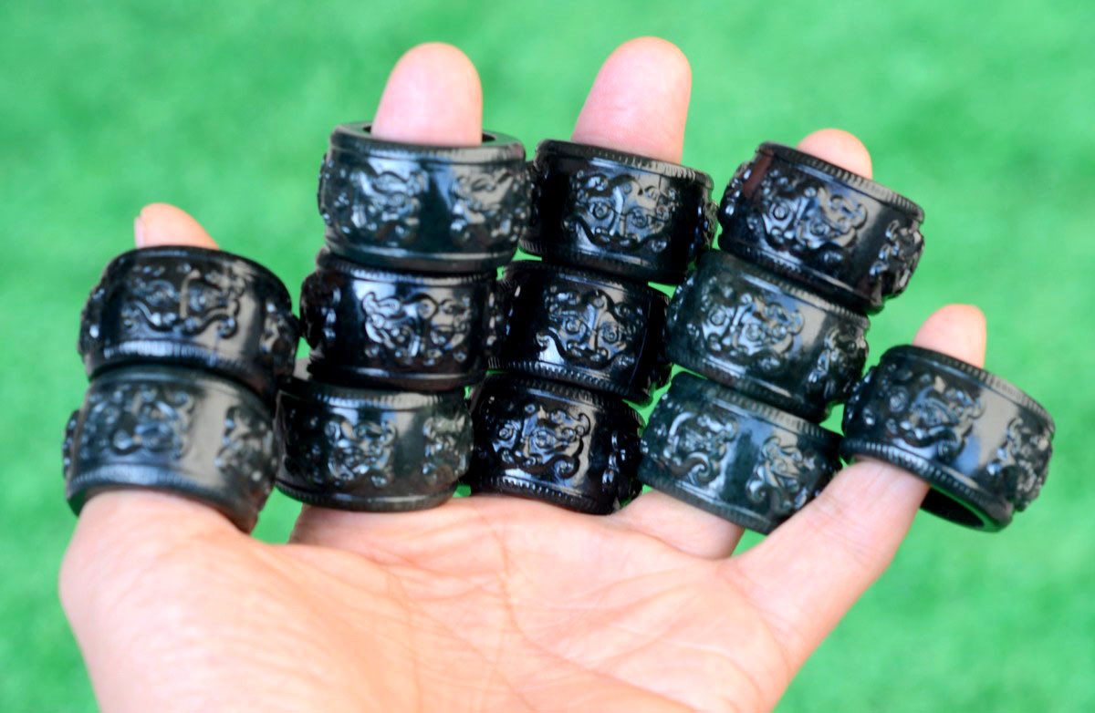 Group of carved nephrite jade thumb rings photographed in natural light